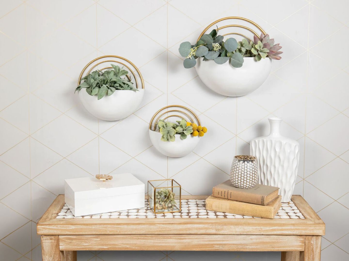 Set of three white floating planters hanging above a wooden table