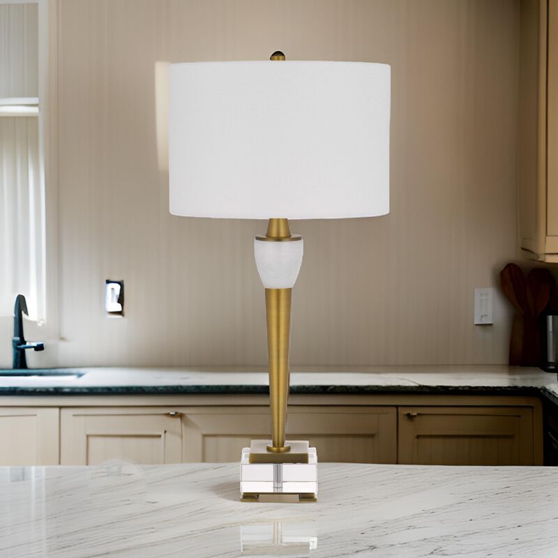 31 Inch Table Lamp with White Drum Shade, Clear Crystal Base, Brass Finish - Benzara